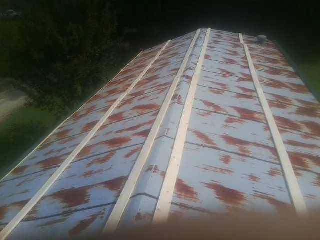 Rusted metal roof panels with new wood purlins before replacement — Storm Damage Roof Repair in Browder by Roofing Brothers