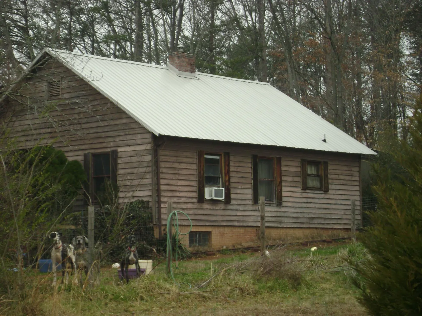 White metal roof on an old wood sided farmhouse, from a Metal Roof Installation job in Browder